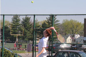 All Ball Junior John Platel serves the ball to his opponent from St. Joe.