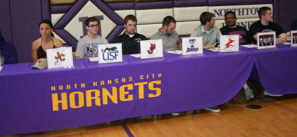 Showing your team colors Seven of the eleven althletes await the announcements of their college signings. Many of the atheletes were proud to be there and happy that the college of their choice wanted them for the sport they love. 