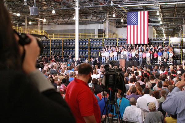 Sierra Smith, junior, photographs President Obama during his visit to the Ford Stamping Plant in Liberty, Mo.