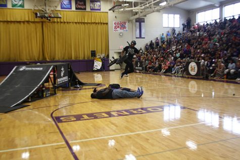 The ASA had some of the kids lay down on the floor, so they could be jumped over. In this image, the biker jumps over him, but not on his bike.