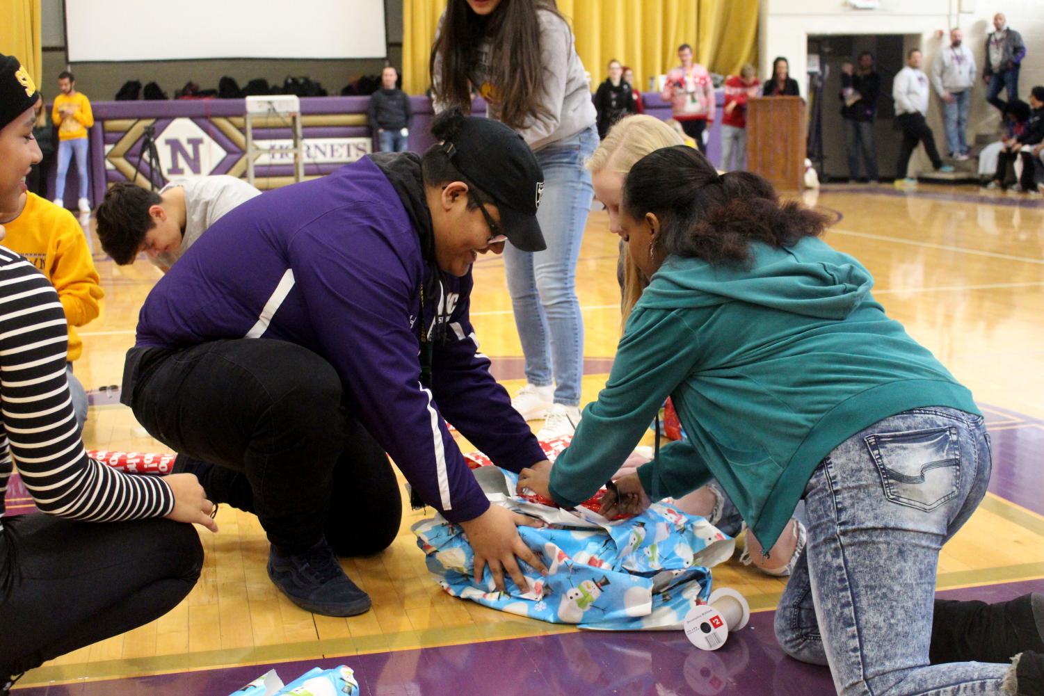 Senior Miguel Rodriguez wraps his team's present for the first spirit stick competition. The seniors won the competition, making it into the third spirit stick event.