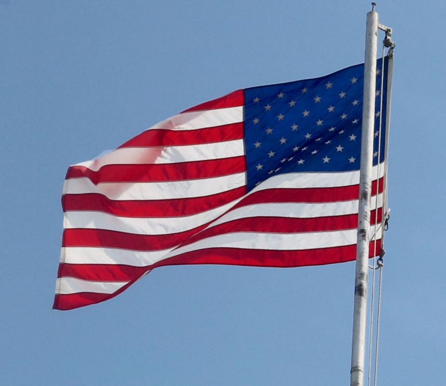 An+American+flag+waves+outside+of+the+North+Kansas+City+High+Schools+Norclay+building.+American+citizens+await+the+undecided+fate+of+the+election.