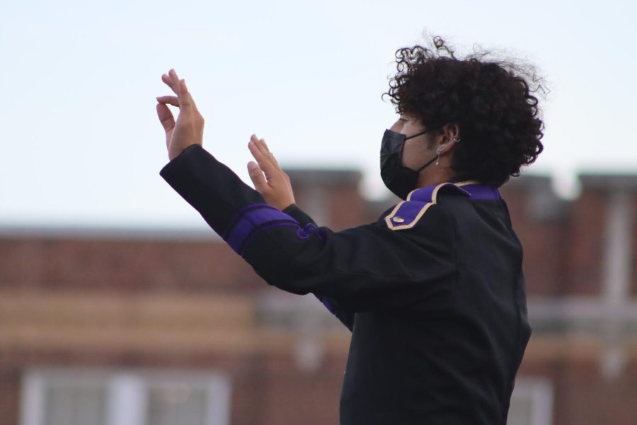 Andres Rodriguez conducts the band during a home game